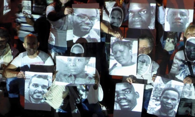 Protesters display photos of the detained activists during the recent night vigil. Photo: Facebook