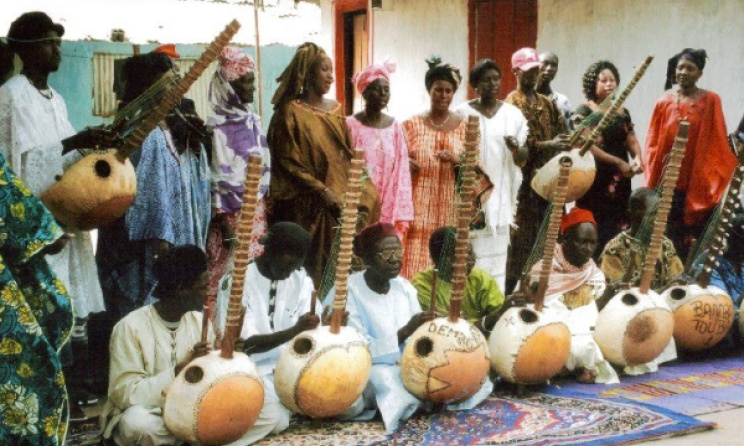 A group playing the kora, one of Gambia's traditional instruments. Photo: Africablogs