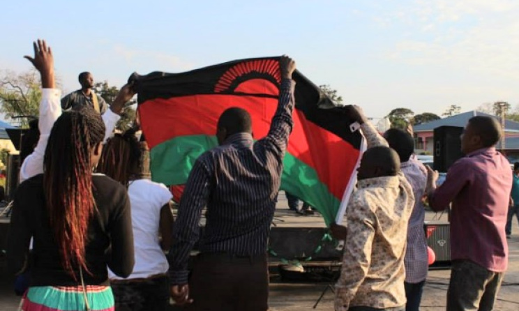 Music fans raise the Malawian flag at the 2014 Ufulu Festival. Photo: Ufulu Festival / Facebook