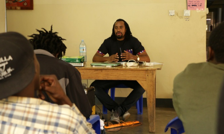 Ugandan artist Navio talks to participants. Photo courtesy of Hip-hop boot camp