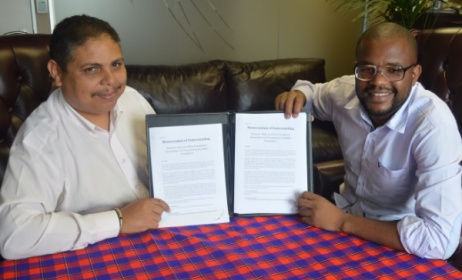 Andre Le Roux and Eddie Hatitye with the MoU between the SAMRO Foundation and the Music In Africa Foundation.